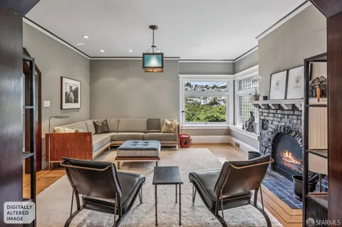 a dining room with furniture a fireplace and wooden floor