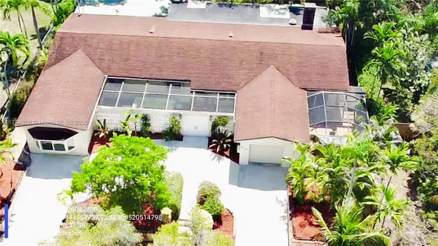 a aerial view of a house with a yard and garden