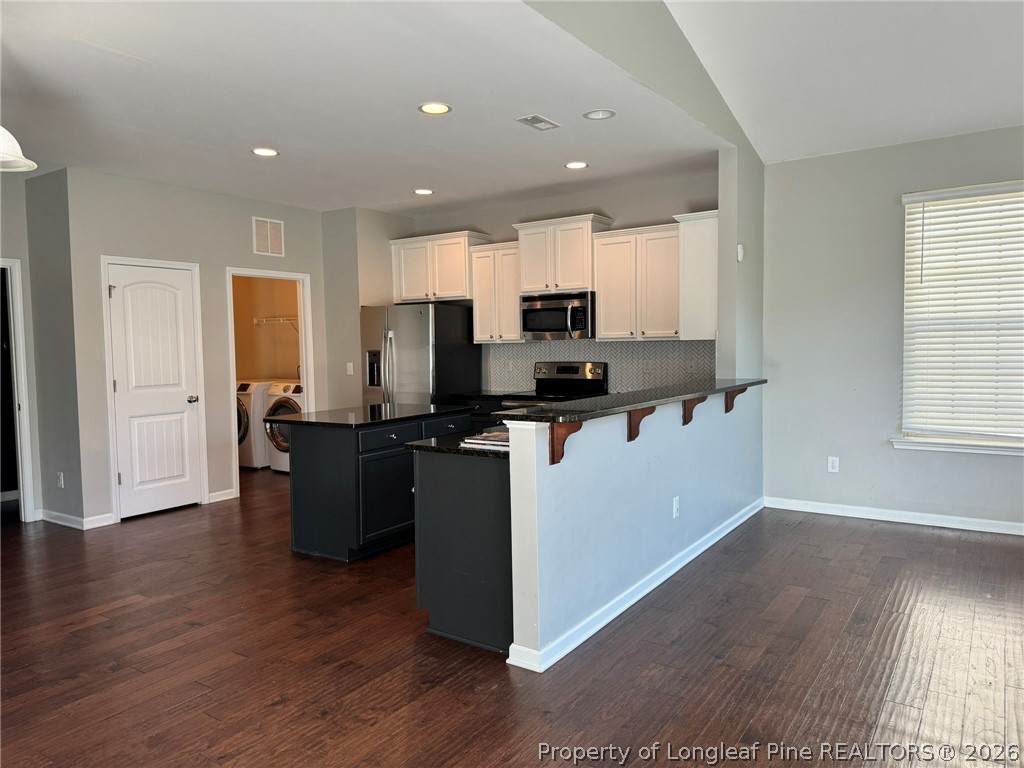 350 River Oak Street Spring Lake, NC 28390 - Photo 11 of 27 a view of kitchen with microwave refrigerator and cabinets