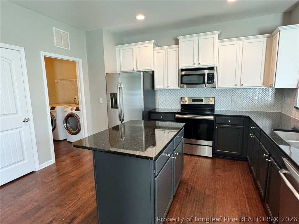350 River Oak Street Spring Lake, NC 28390 - Photo 14 of 27 a kitchen with stainless steel appliances granite countertop a sink stove and refrigerator