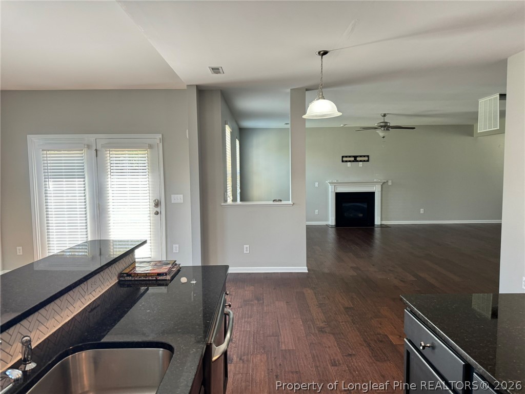 350 River Oak Street Spring Lake, NC 28390 - Photo 9 of 27 an empty room with wooden floor and windows