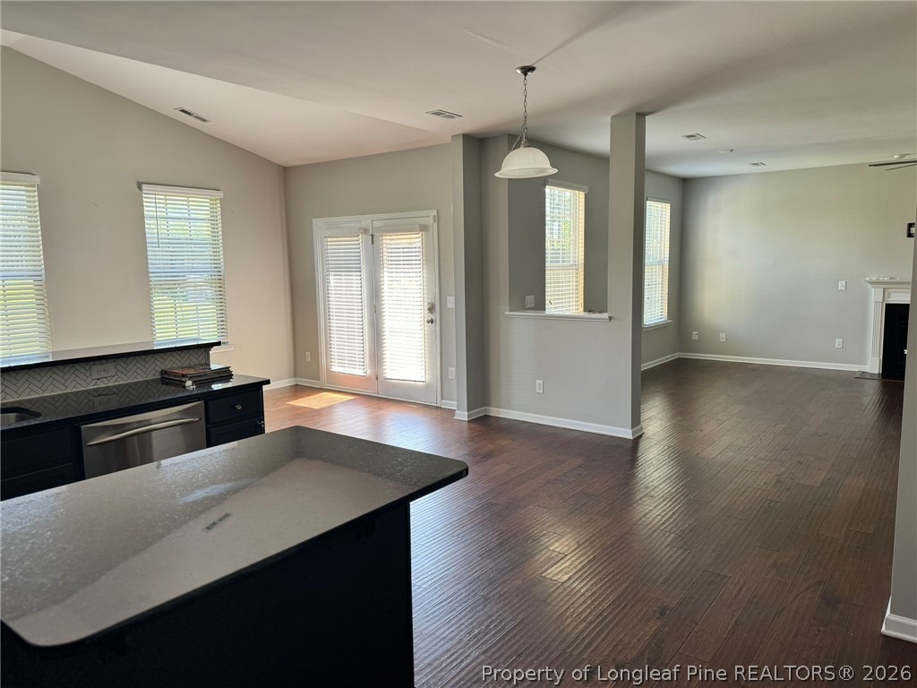 350 River Oak Street Spring Lake, NC 28390 - Photo 10 of 27 a kitchen with stainless steel appliances a kitchen island hardwood floor sink stove and wooden cabinets