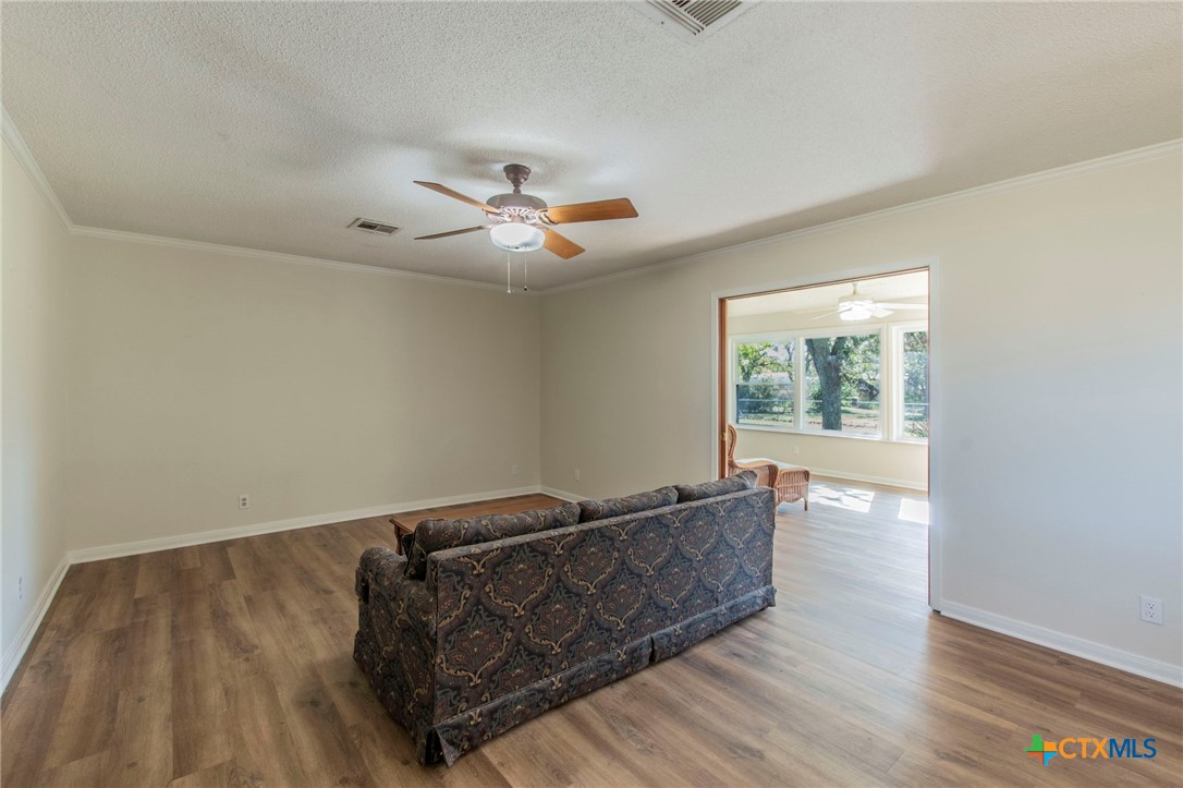 517 Thompson Road Troy, TX 76579 - Photo 2 of 25 a living room with hard wood floors and a ceiling fan