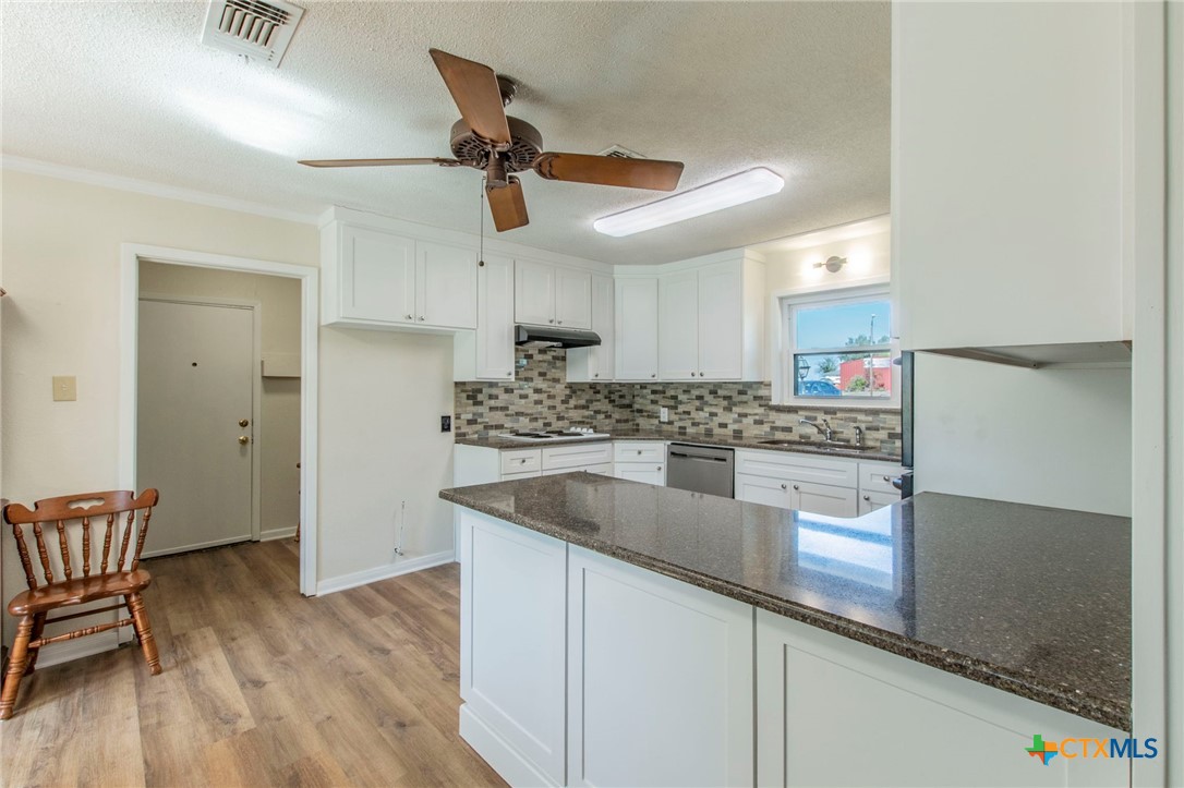 517 Thompson Road Troy, TX 76579 - Photo 6 of 25 a kitchen with stainless steel appliances granite countertop a sink a stove and a wooden floors