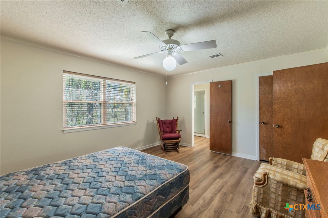 517 Thompson Road Troy, TX 76579 - Photo 10 of 25 a bedroom with a bed and a chandelier