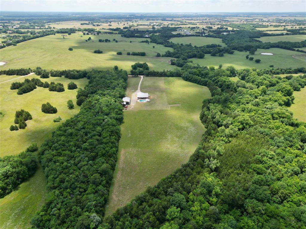 1524 County Road Sumner, TX 75486 - Photo 2 of 35 Expansive rural property featuring open fields and dense tree lines