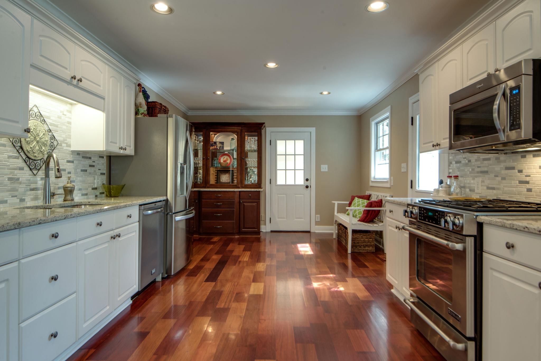 This Beautiful Kitchen has Stainless Steel Appliances to Include a Jenn-Air Gas Range, Granite and Tile Backsplash
