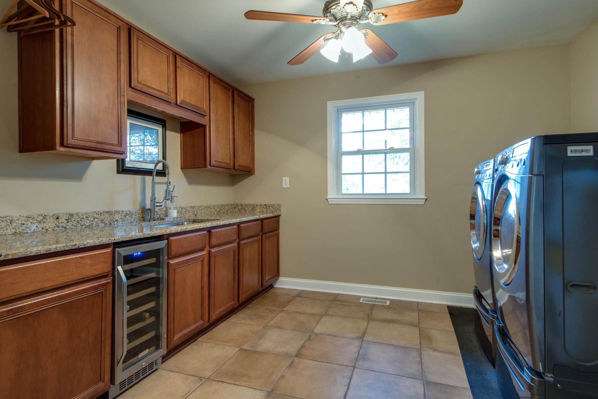 Large 12x11 Laundry Room with Built in Cabinets, Granite Counters, Oversized Sink and a Built-In Wine Refrigerator