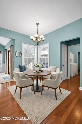 a view of a dining room with furniture and wooden floor