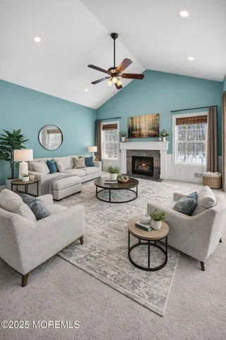a living room with furniture fireplace and a large window