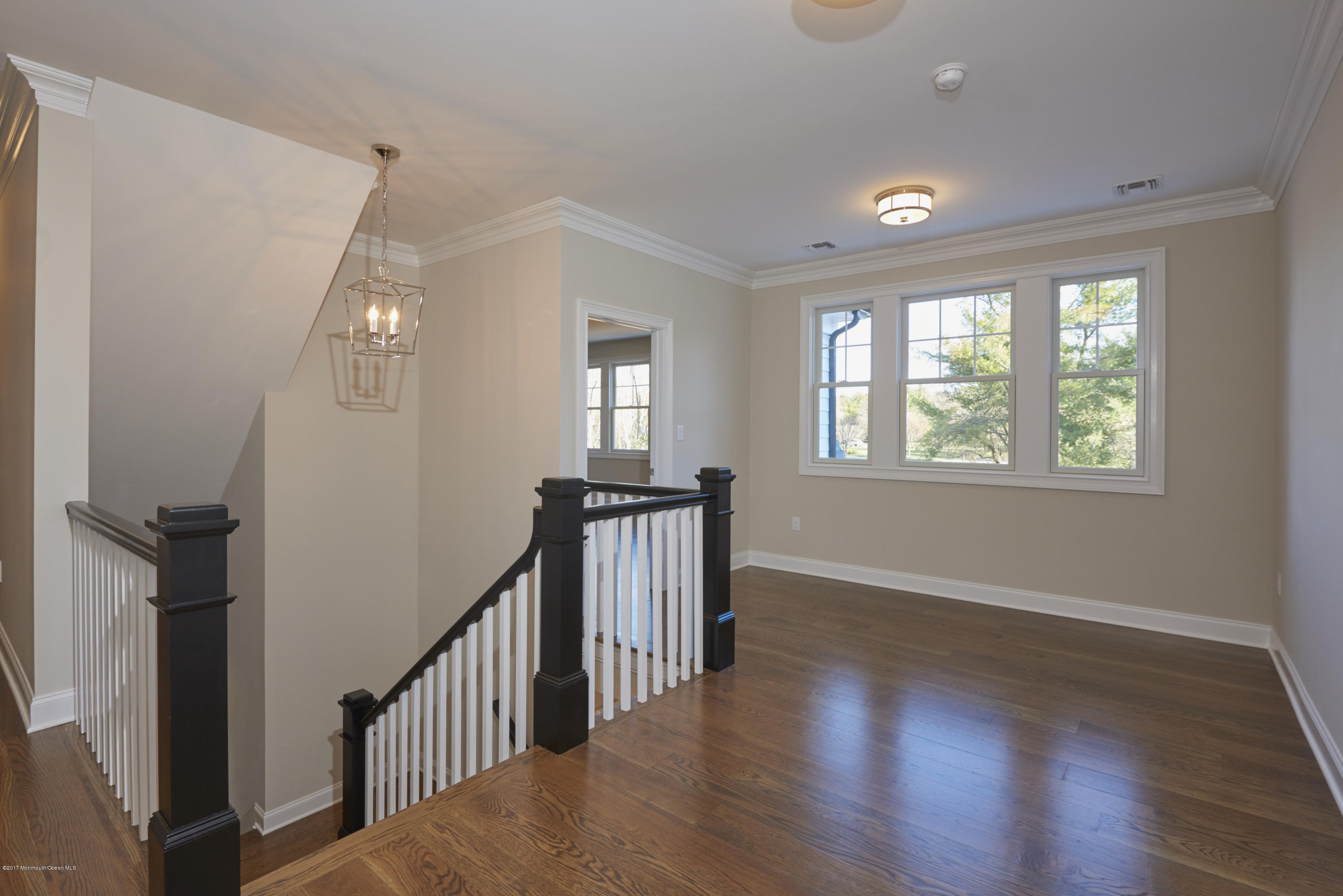 3 Forrest Way Colts Neck, NJ 07722 - Photo 18 of 26 a view of a room with wooden floor stairs and windows