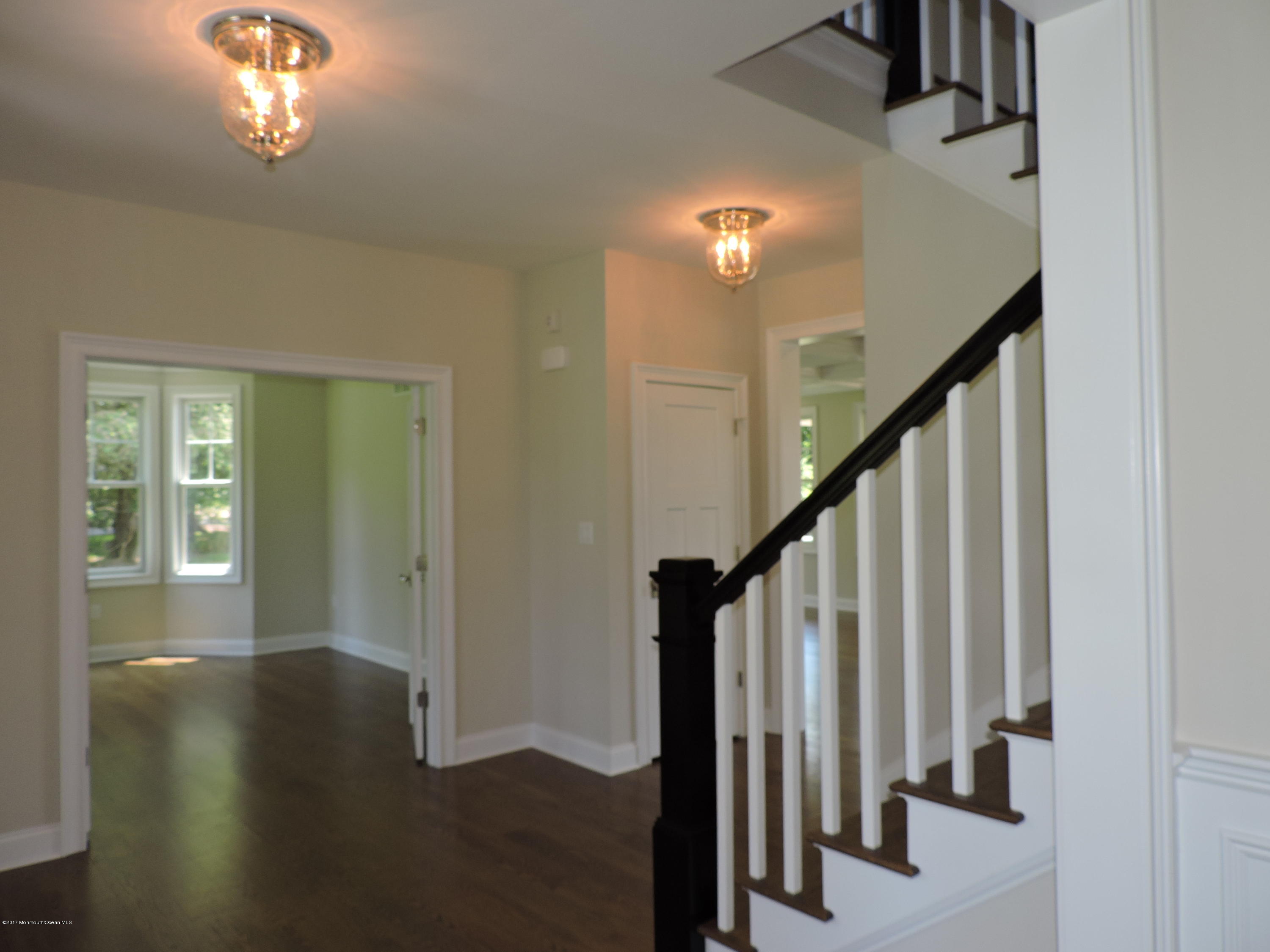 3 Forrest Way Colts Neck, NJ 07722 - Photo 4 of 26 a view of a hallway with wooden floor and staircase