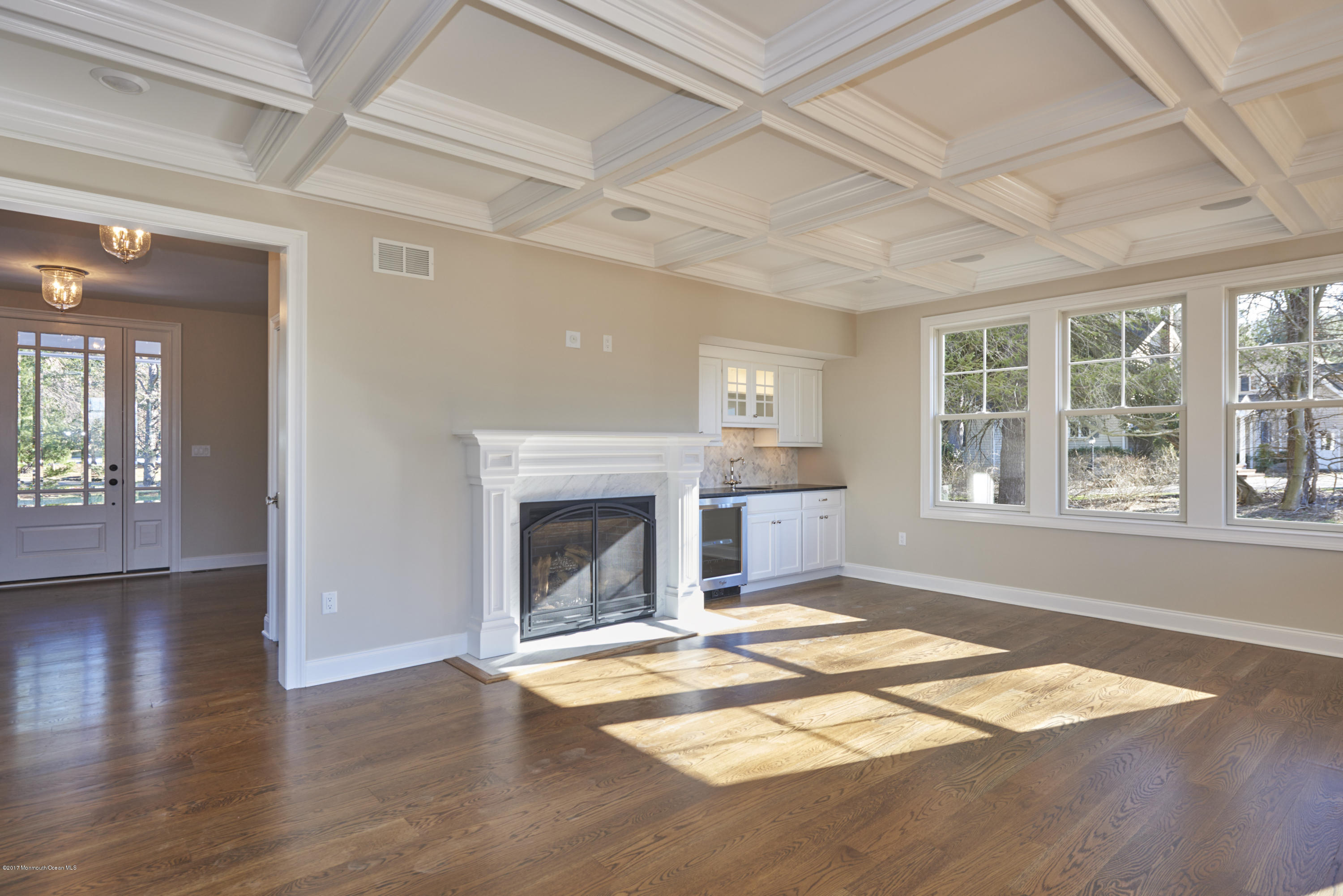 3 Forrest Way Colts Neck, NJ 07722 - Photo 8 of 26 an empty room with wooden floor fireplace and windows