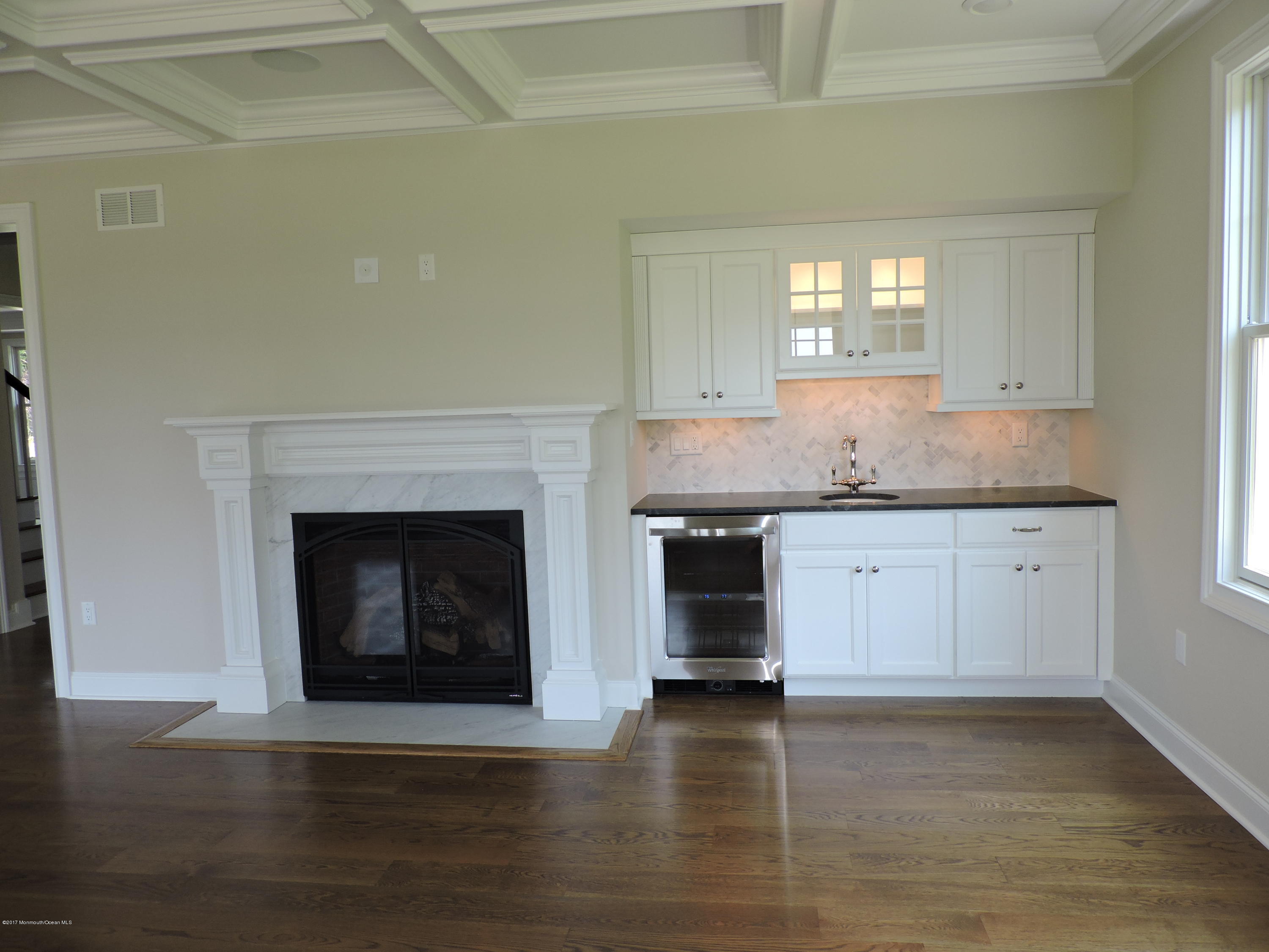 3 Forrest Way Colts Neck, NJ 07722 - Photo 9 of 26 a kitchen with granite countertop a fireplace a stove and a wooden floors