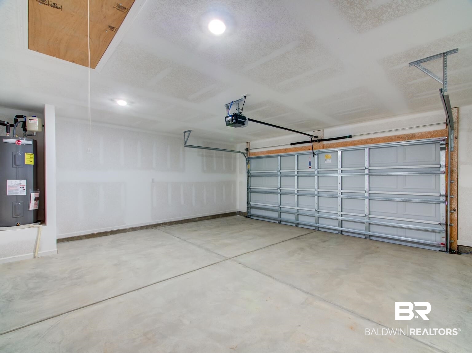 23952 Citation Loop Daphne, AL 36526 - Photo 33 of 69 Garage featuring electric water heater, a garage door opener, and recessed lighting