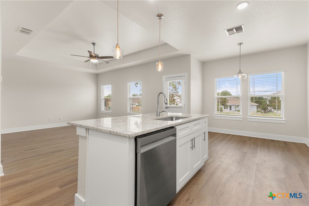 952 Rimrock Cove Spring Branch, TX 78070 - Photo 19 of 39 a kitchen with a sink a window and wooden floor