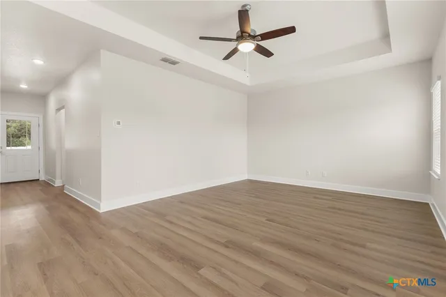 wooden floor in an empty room with a window