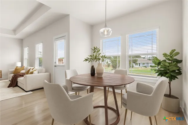 a view of a dining room with furniture window and wooden floor
