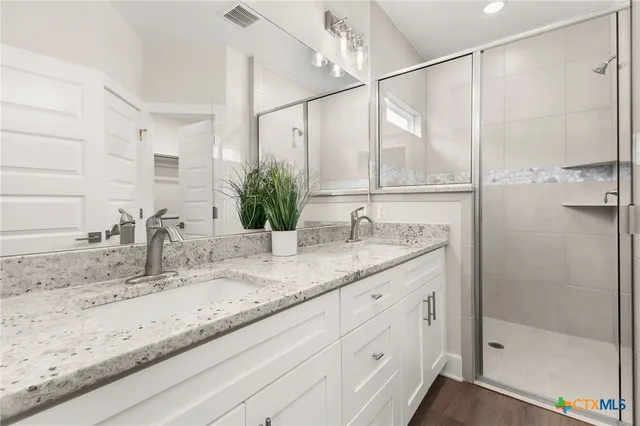 a bathroom with a granite countertop sink mirror and double