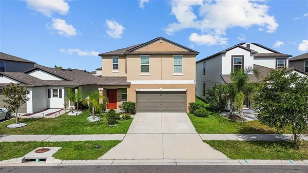 a front view of house with yard and green space