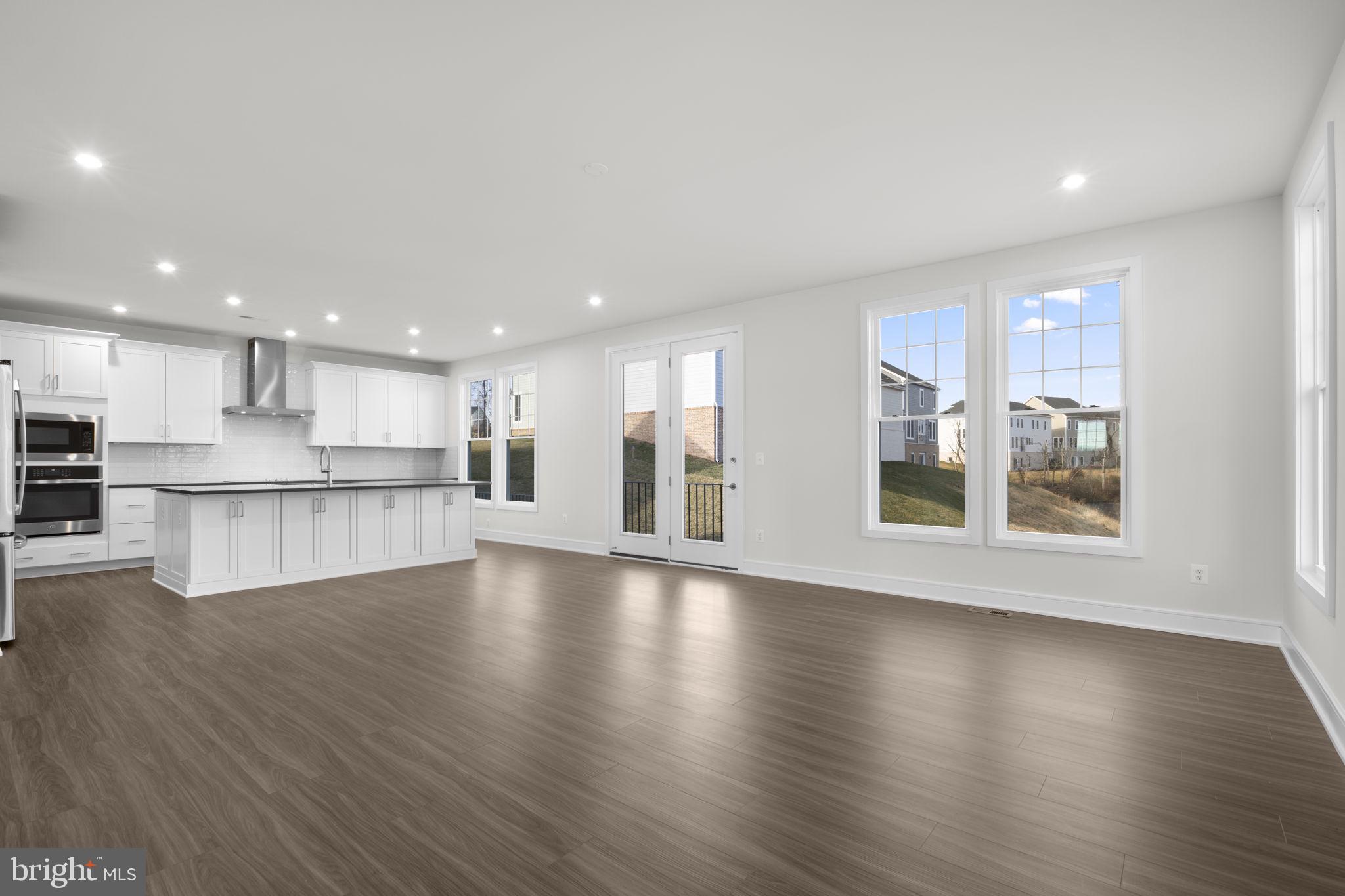 2611 Blue Rdg Avenue, Unit HOMESITE 139 Marshall, VA 20115 - Photo 11 of 49 a view of an empty room with wooden floor and a kitchen