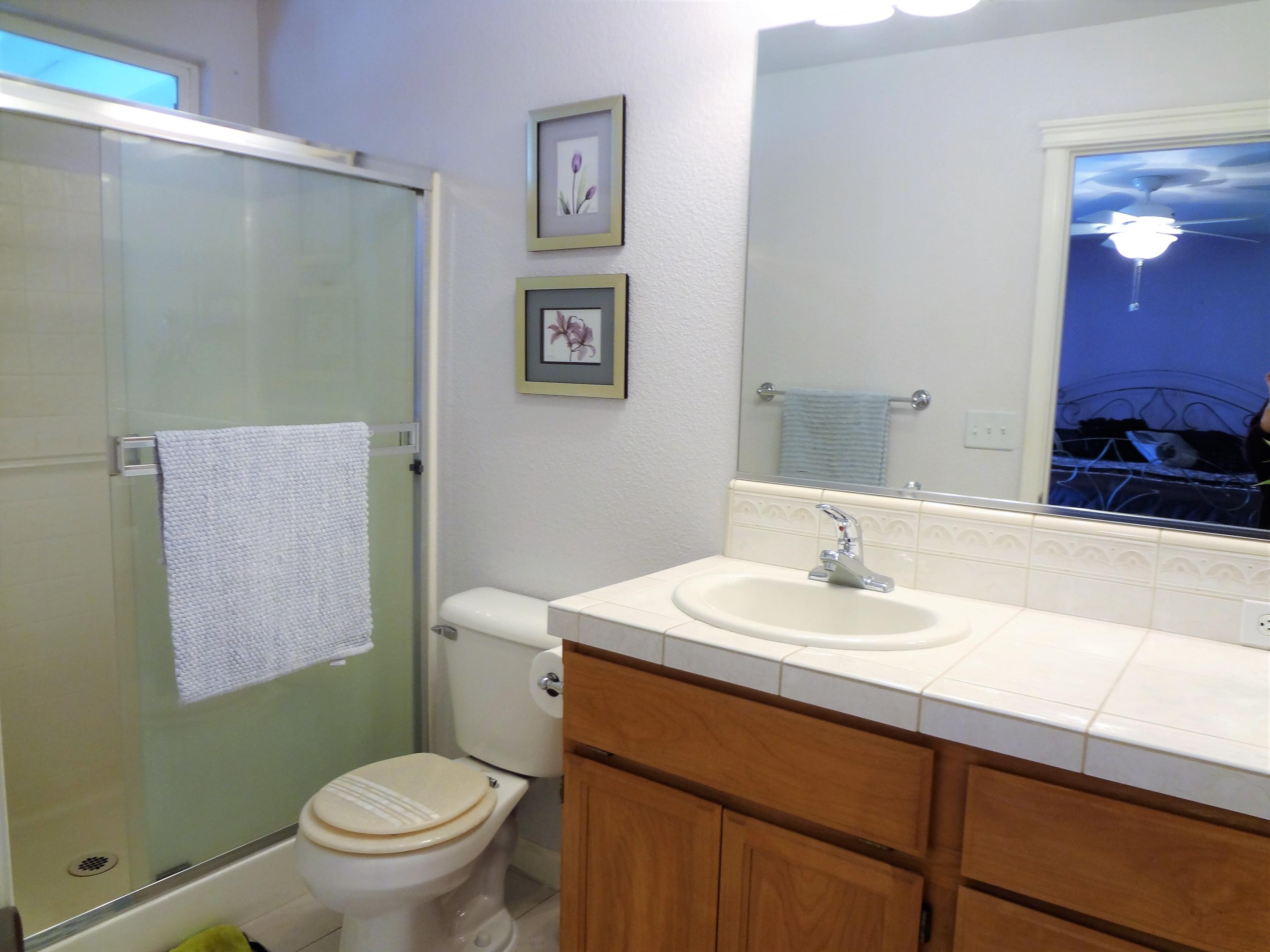 7759 Pit Road Redding, CA 96001 - Photo 21 of 47 a bathroom with a sink a toilet and mirror
