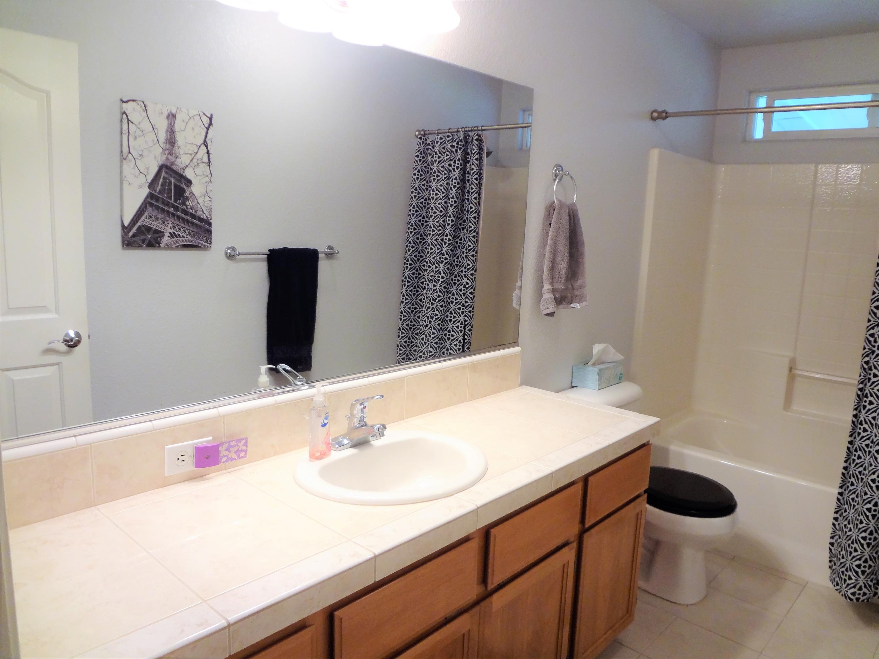 7759 Pit Road Redding, CA 96001 - Photo 24 of 47 a bathroom with a sink vanity mirror and toilet