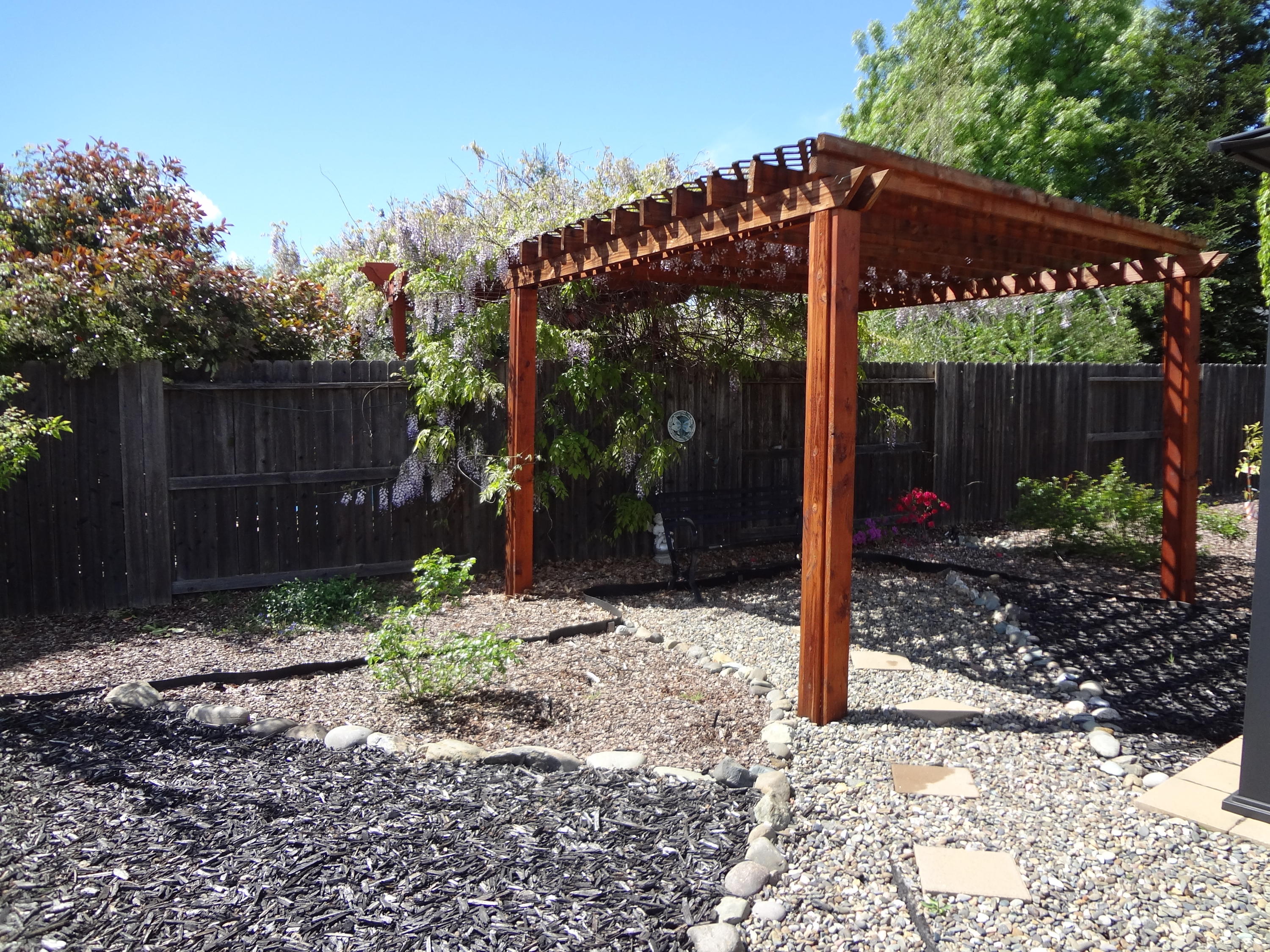 7759 Pit Road Redding, CA 96001 - Photo 35 of 47 a view of a backyard with plants and large trees