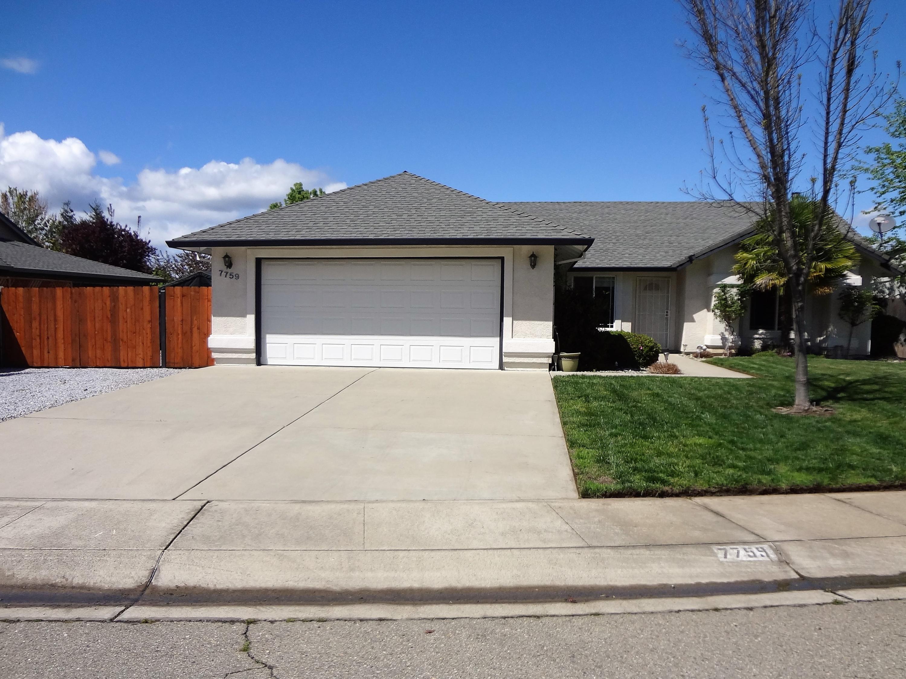 7759 Pit Road Redding, CA 96001 - Photo 45 of 47 a front view of a house with a yard and garage