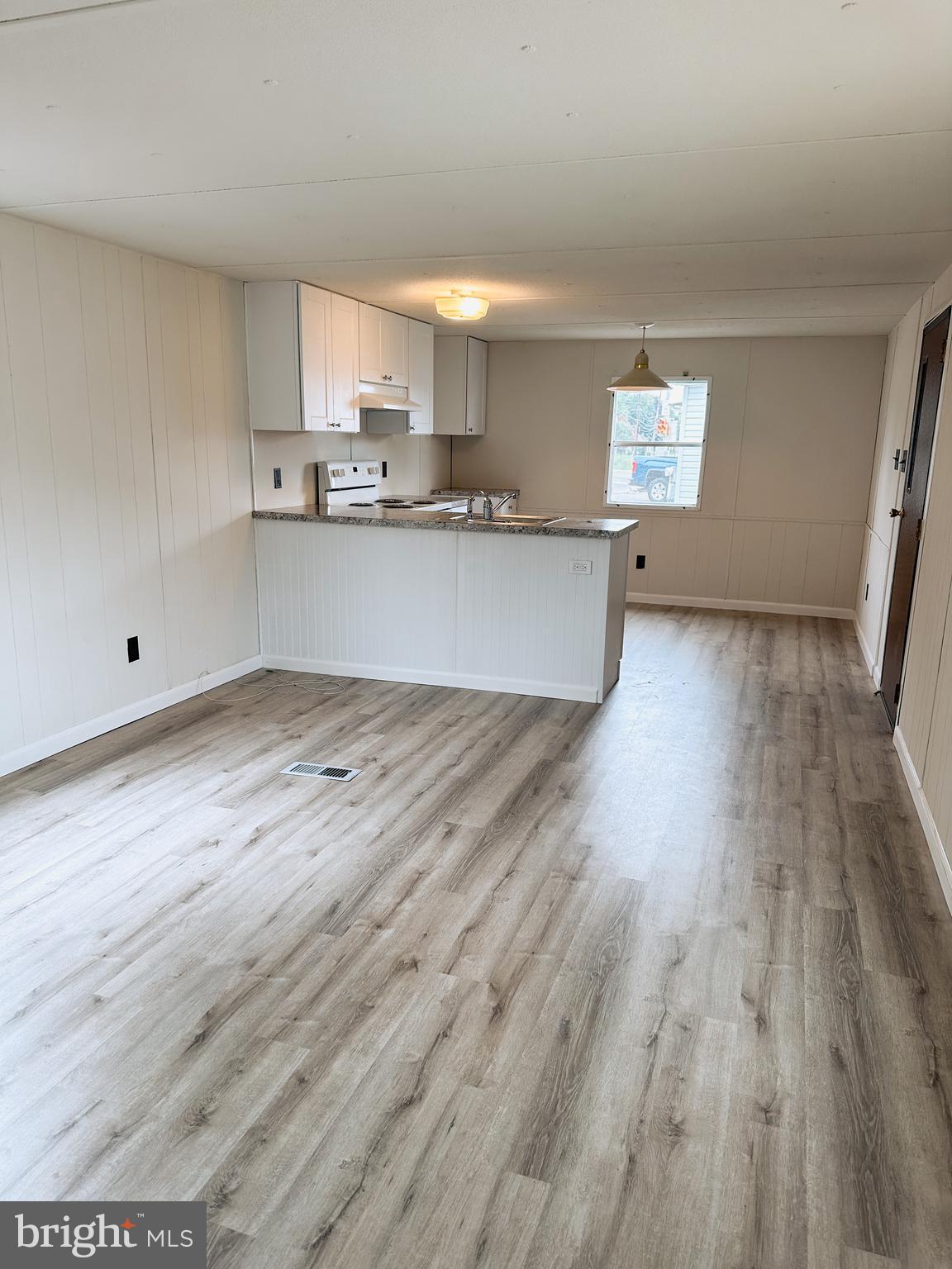 600 Convent Road, Unit 3 Aston, PA 19014 - Photo 3 of 7 a view of a kitchen with wooden floor and electronic appliances
