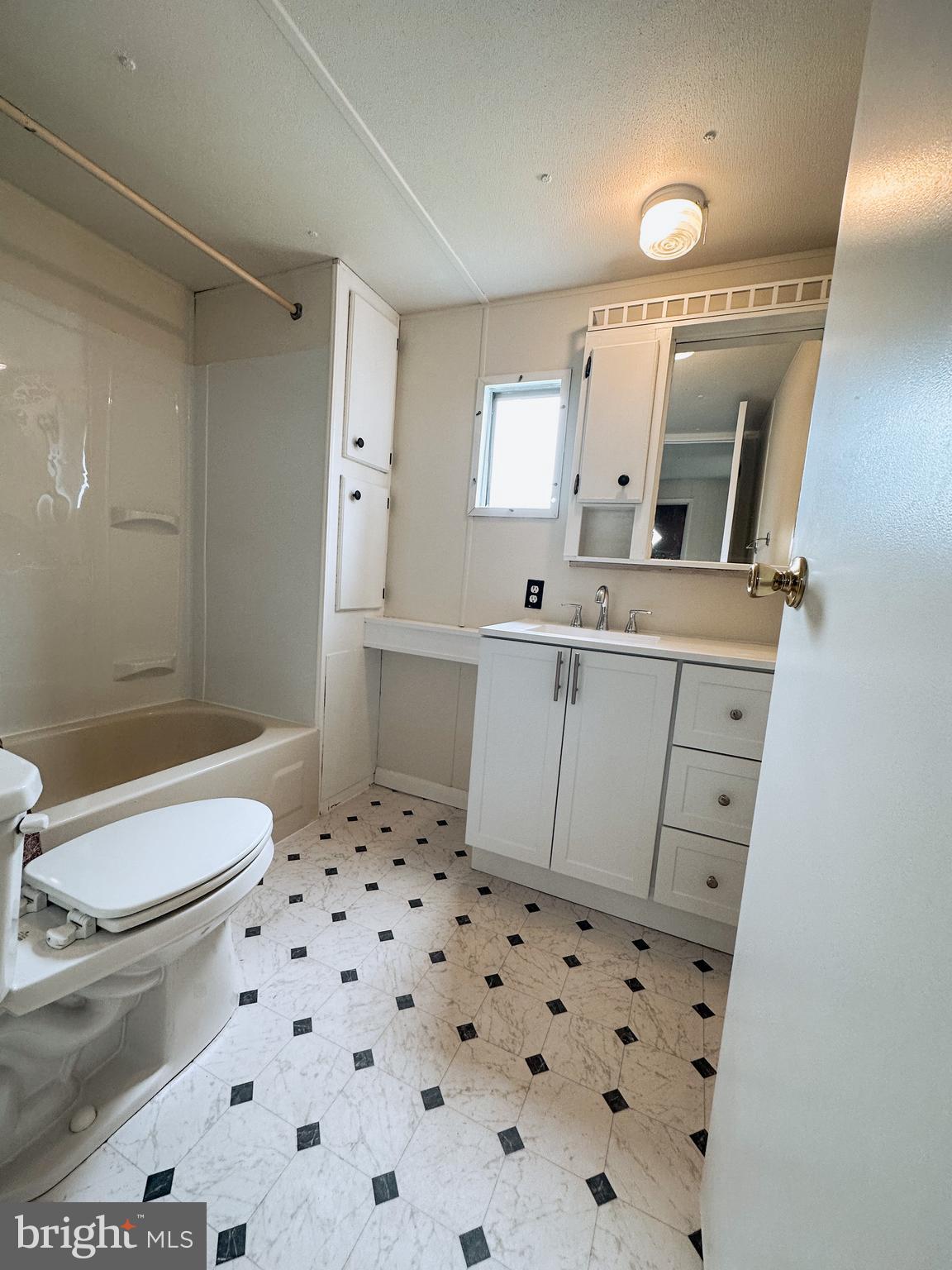 600 Convent Road, Unit 3 Aston, PA 19014 - Photo 6 of 7 a bathroom with a sink toilet a mirror and shower