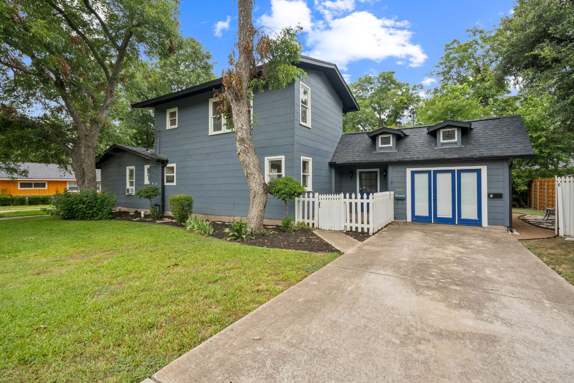 a front view of a house with a garden