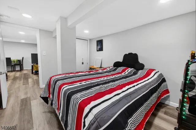 a bedroom with bed and a potted plant