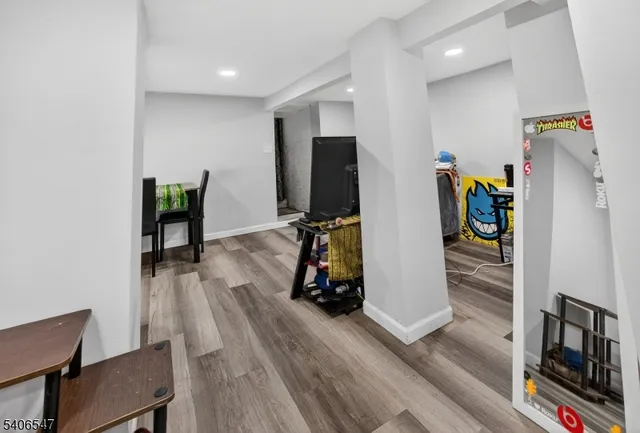 a view of a hallway with wooden floor and windows