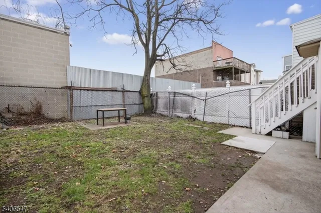 a white house that has tree in front of it