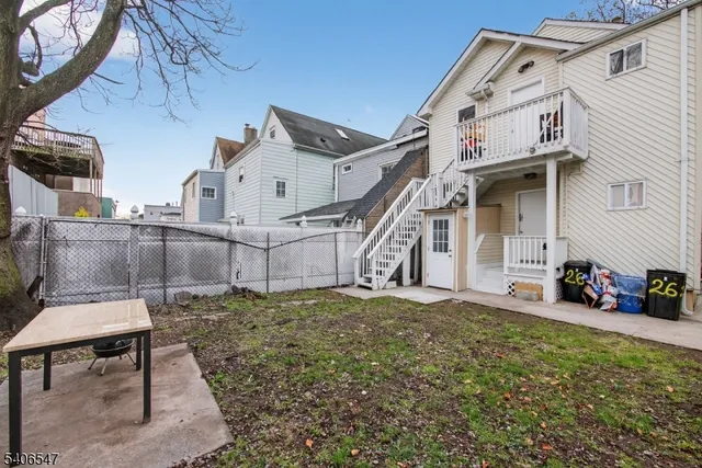 a view of a chairs and table in the backyard