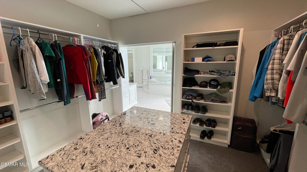780 Gloucester Lane Thousand Oaks, CA 91362 - Photo 16 of 32 a view of walk in closet with clothes and shoes