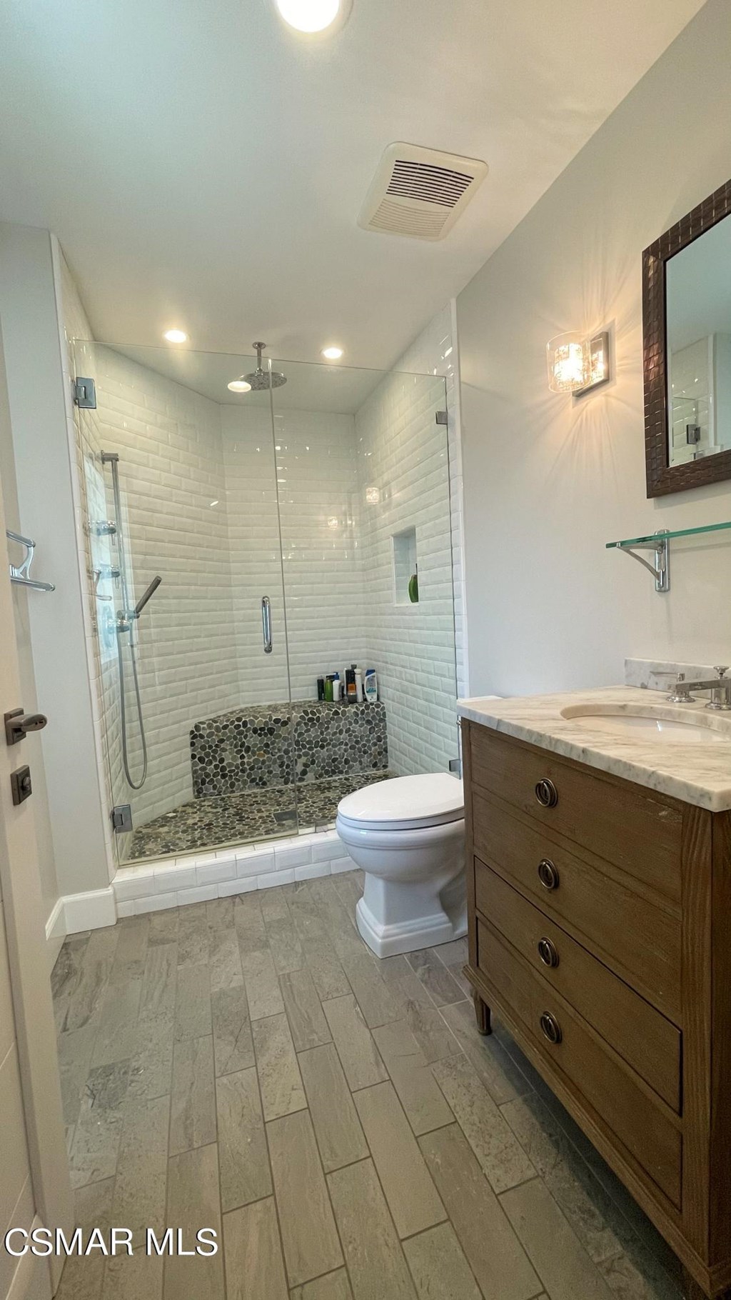 780 Gloucester Lane Thousand Oaks, CA 91362 - Photo 27 of 32 a bathroom with a granite countertop sink a toilet a mirror and shower
