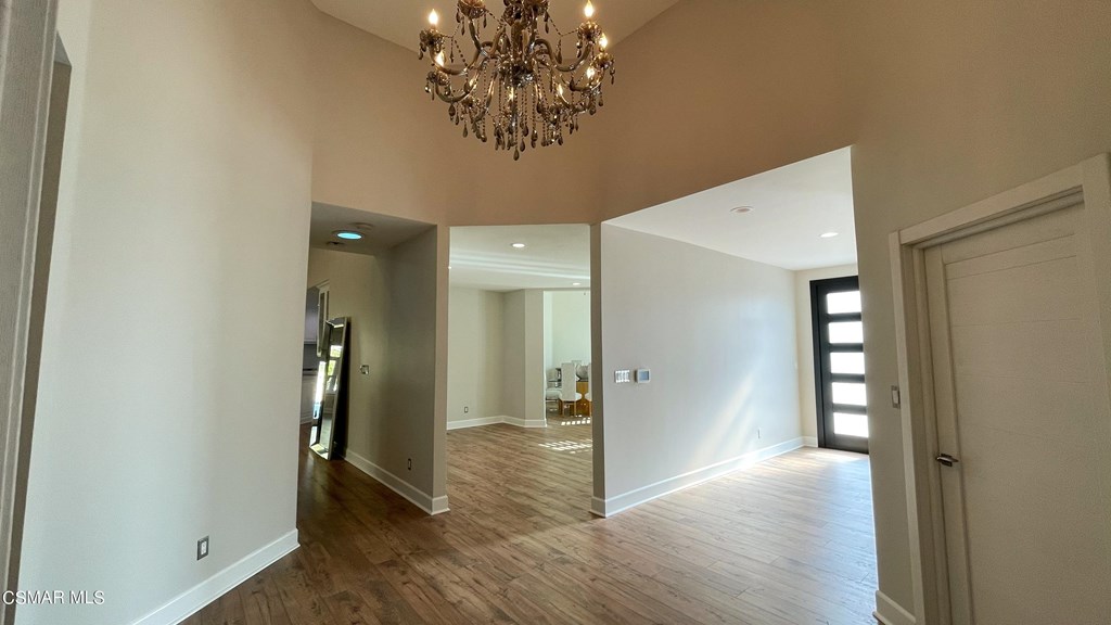 780 Gloucester Lane Thousand Oaks, CA 91362 - Photo 5 of 32 a view of a hallway with wooden floor and a chandelier