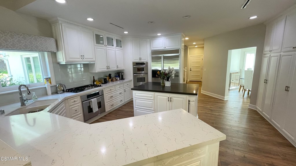 780 Gloucester Lane Thousand Oaks, CA 91362 - Photo 10 of 32 a kitchen with stainless steel appliances a sink a stove top oven a counter space and cabinets