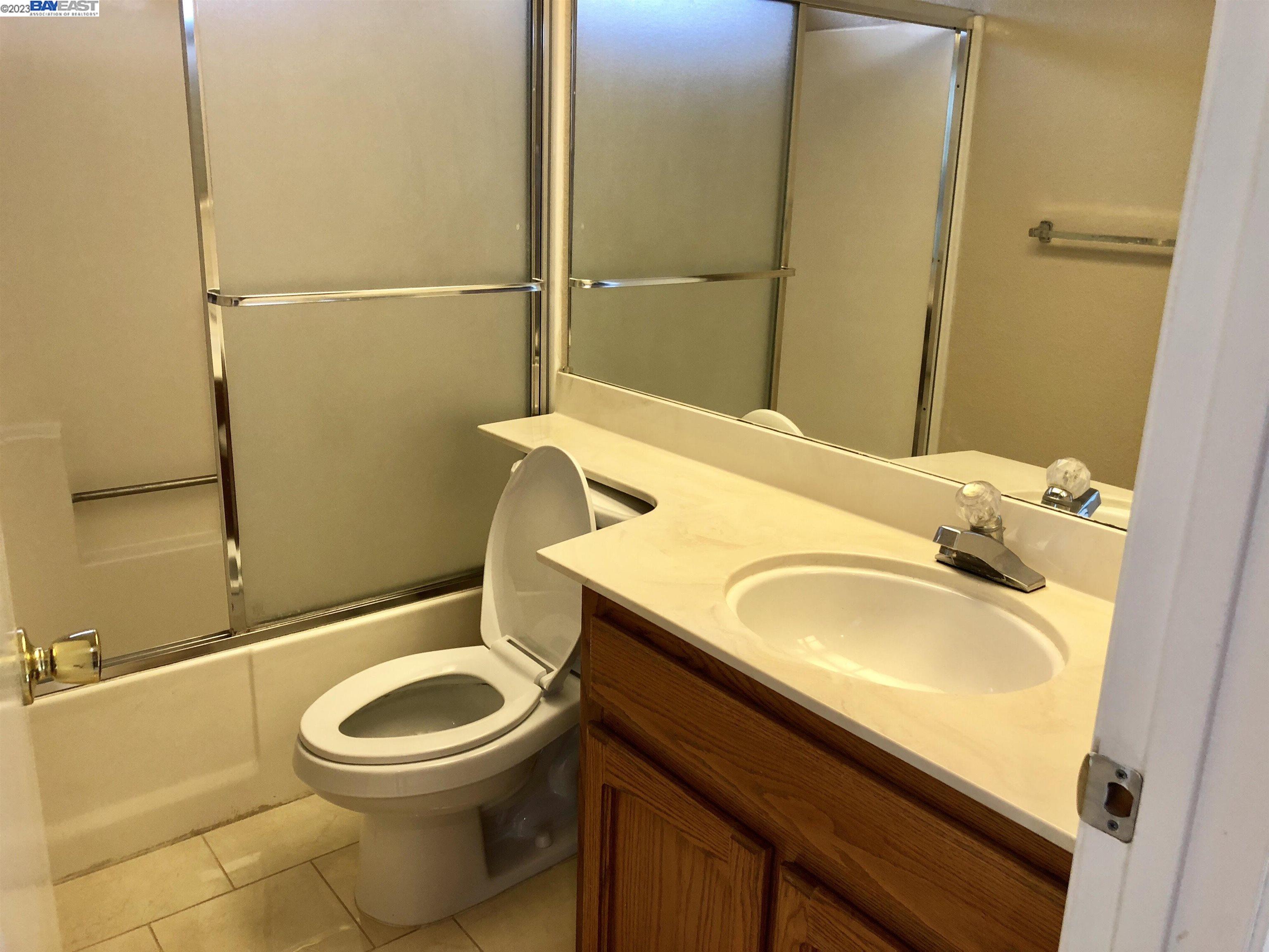 3047 Badger Drive Pleasanton, CA 94566 - Photo 11 of 18 a bathroom with a sink a toilet and shower