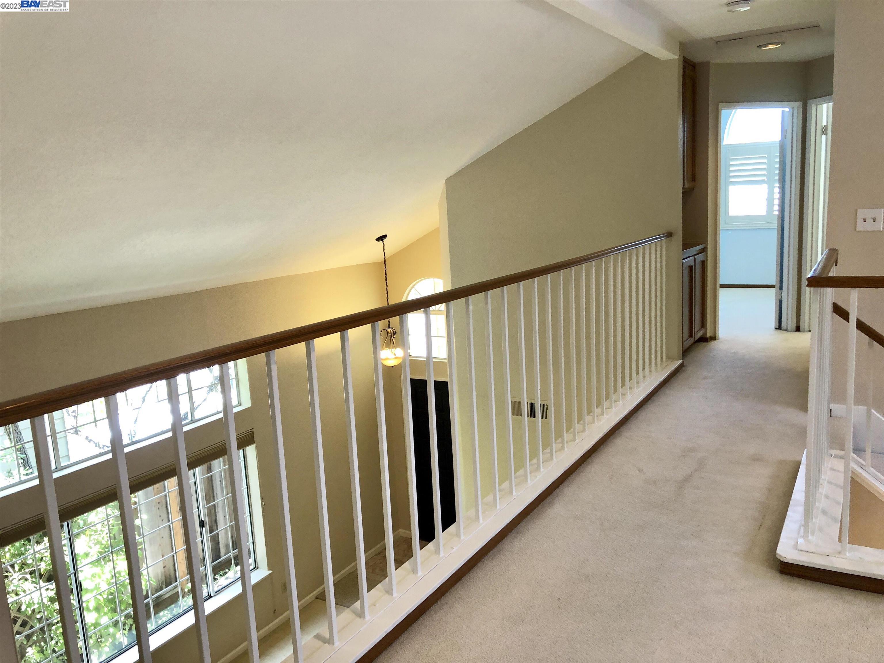 3047 Badger Drive Pleasanton, CA 94566 - Photo 13 of 18 a view of a hallway with wooden floor and staircase