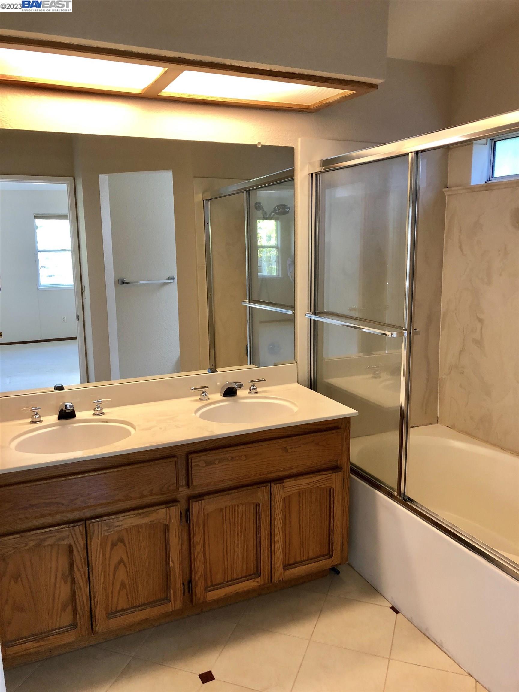 3047 Badger Drive Pleasanton, CA 94566 - Photo 18 of 18 a bathroom with a double vanity sink and mirror