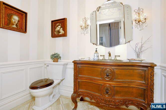 164 Deerhaven Road Mahwah, NJ 07430 - Photo 15 of 42 a bathroom with a toilet a sink and mirror