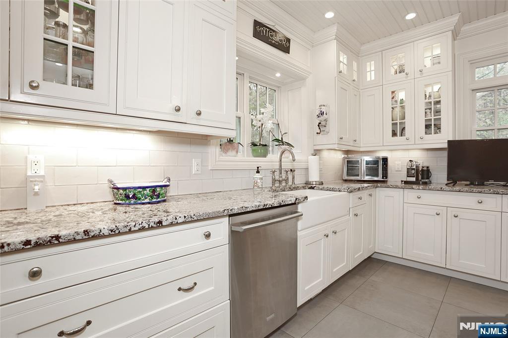 164 Deerhaven Road Mahwah, NJ 07430 - Photo 20 of 42 a kitchen with granite countertop white cabinets and white stainless steel appliances