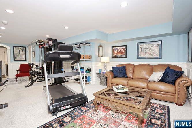 164 Deerhaven Road Mahwah, NJ 07430 - Photo 30 of 42 a living room with furniture a rug and gym equipment