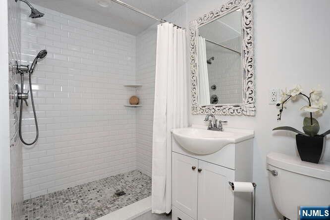 164 Deerhaven Road Mahwah, NJ 07430 - Photo 32 of 42 a bathroom with a sink toilet and shower
