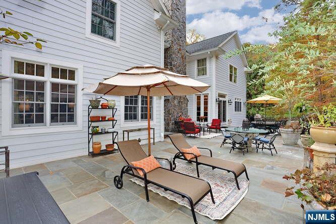 164 Deerhaven Road Mahwah, NJ 07430 - Photo 35 of 42 a view of a patio with table and chairs under an umbrella