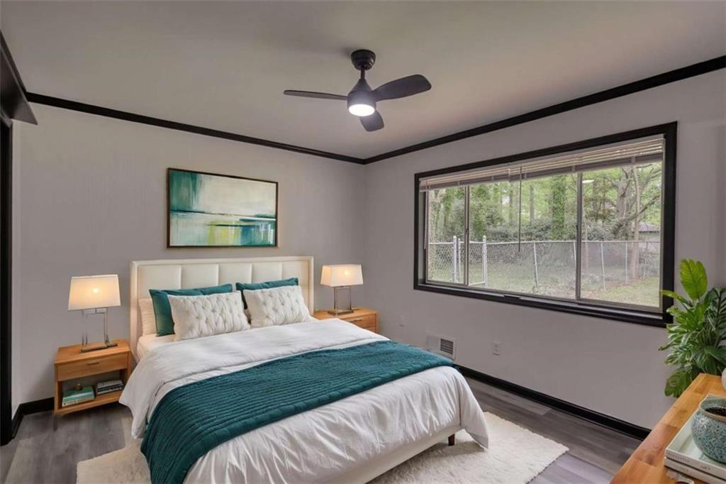 555 Joy Street Jackson, GA 30233 - Photo 39 of 56 a bedroom with a large bed and a large window