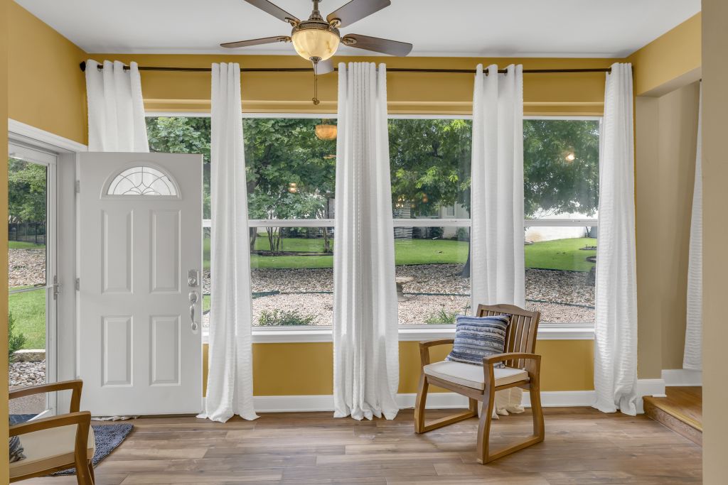 144 Cattle Trail Way Georgetown, TX 78633 - Photo 13 of 37 Luminous entry area with full-height windows offering natural views and access to the outdoors.